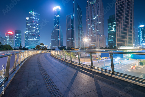 footbridge with cityscape at night in Shanghai China.