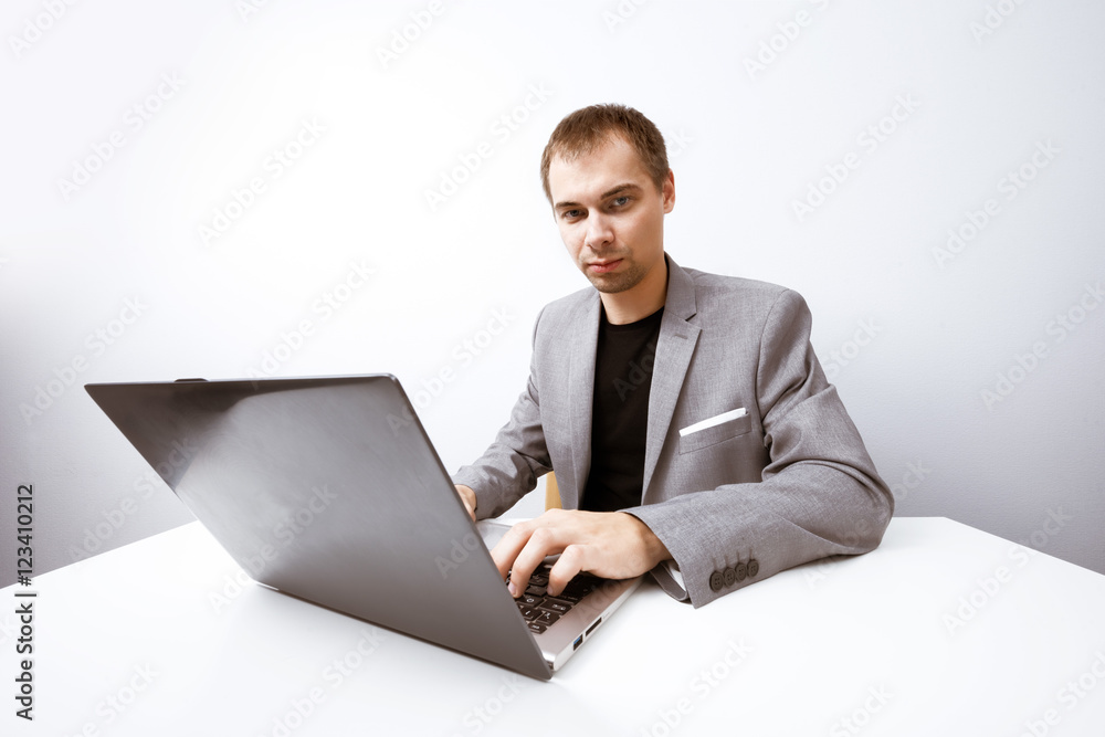 Handsome businessman works with laptop in office Handsome businessman works with laptop in office