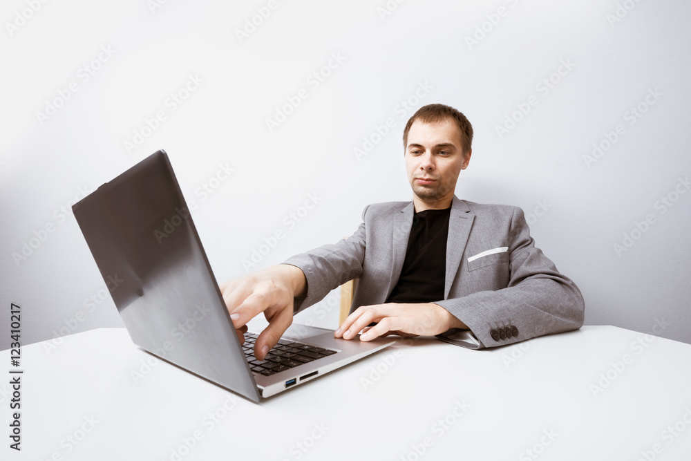 Handsome businessman working with laptop in office Handsome businessman working with laptop in office