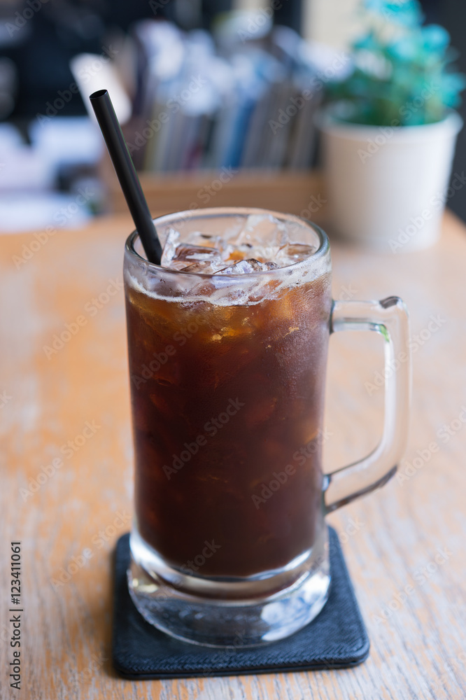 Iced Americano black coffee on a wooden table. shallow depth of