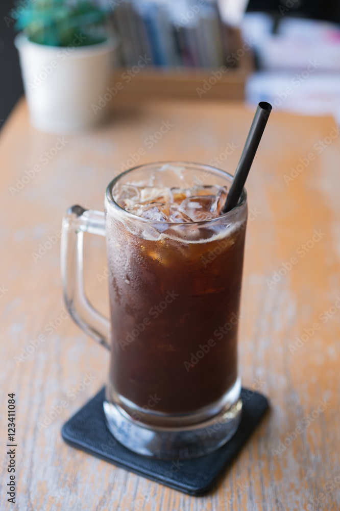 Iced Americano black coffee on a wooden table. shallow depth of