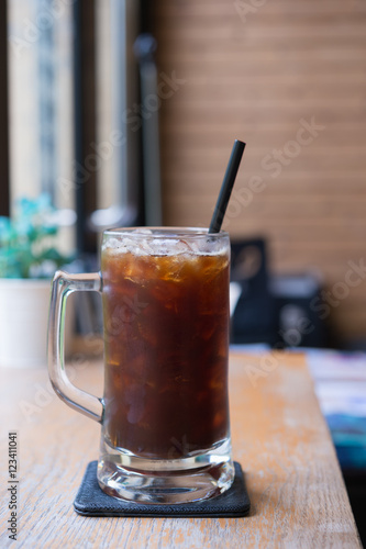 Obraz na płótnie Iced Americano black coffee on a wooden table. shallow depth of w salonie