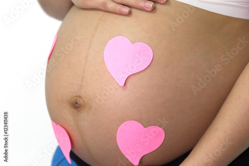 Wallpaper Mural Pregnant woman is hands shape heart around pink paper note on be Torontodigital.ca