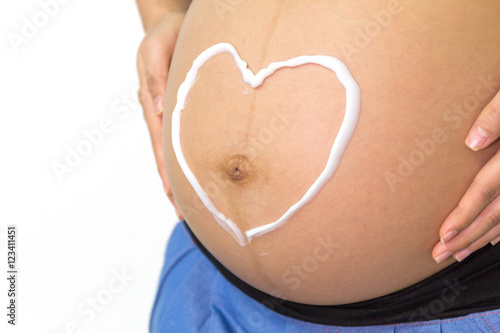 Wallpaper Mural Pregnant woman hand lotion shape heart help skin belly. Torontodigital.ca