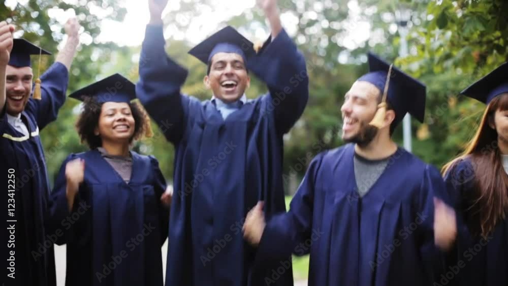 happy students in mortar boards with diplomas happy students in mortar boards with diplomas