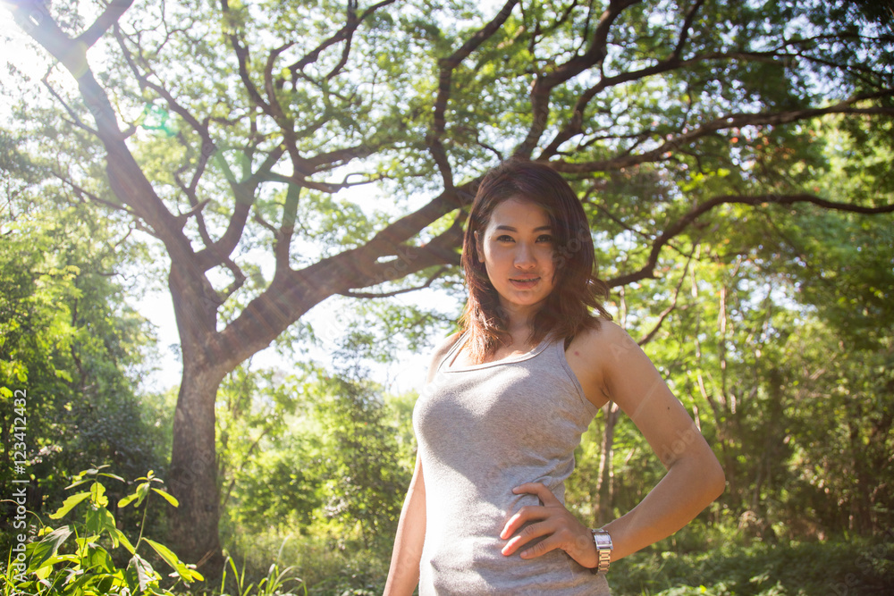 Beautiful young woman is in the green forest Beautiful young woman is in the green forest
