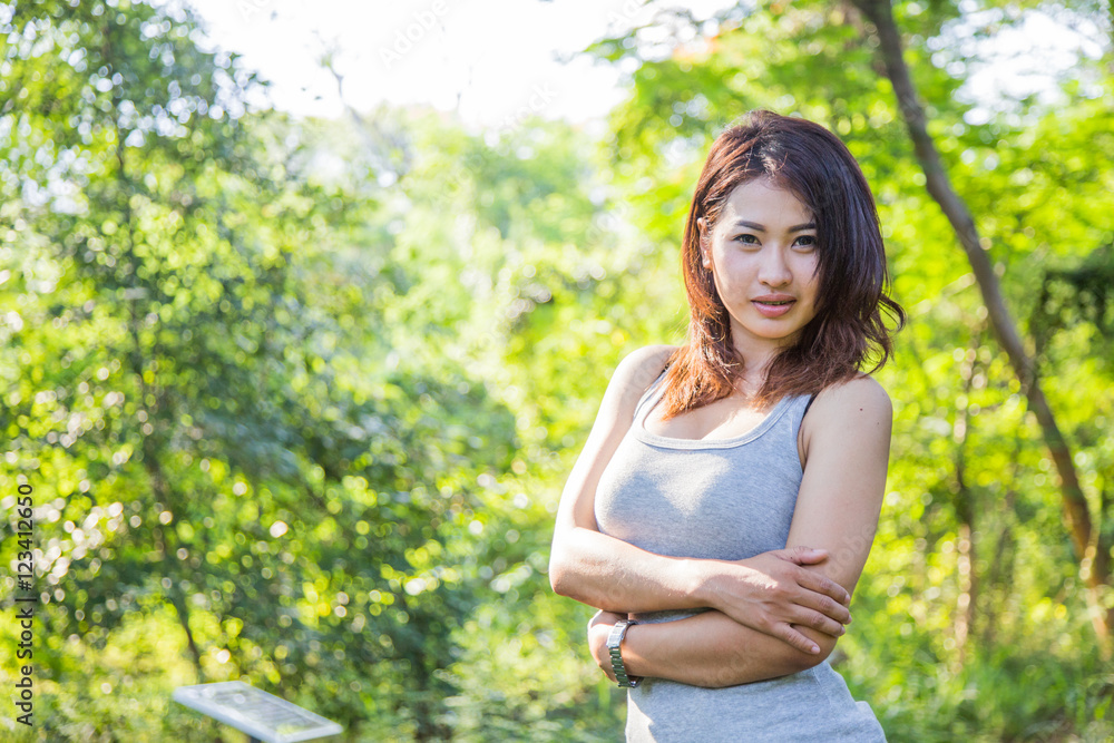 Beautiful young woman is in the green forest Beautiful young woman is in the green forest