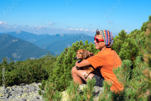 Young hiker with a small dog