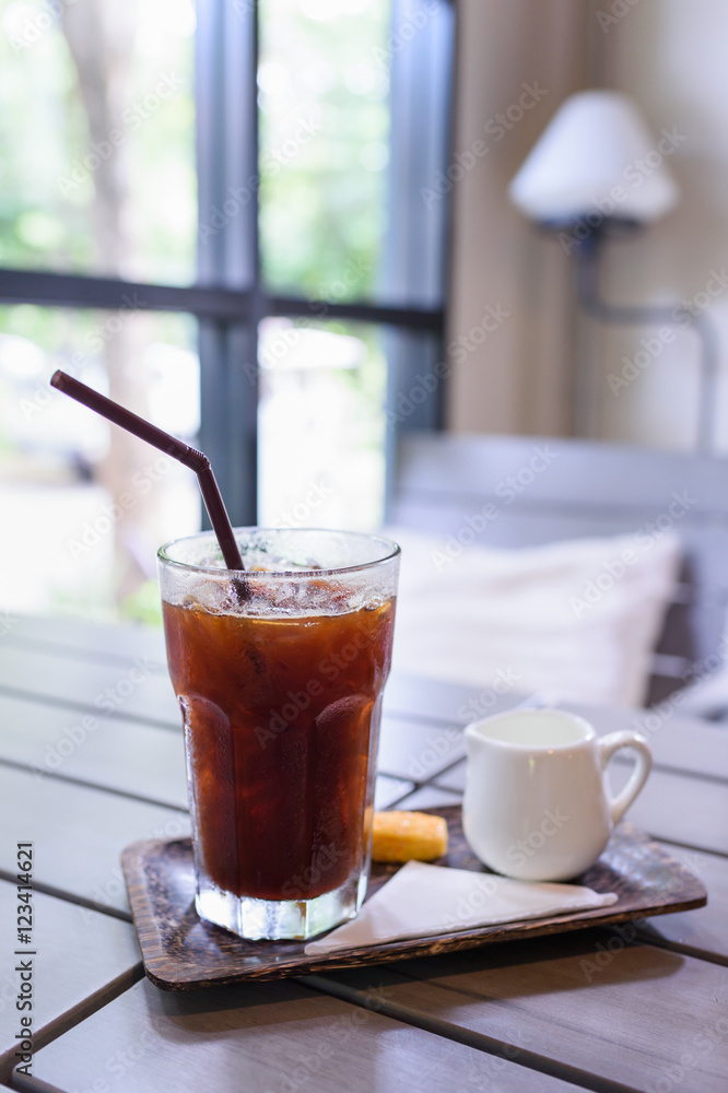 Iced Americano black coffee on a wooden table. shallow depth of