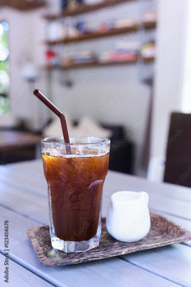 Iced Americano black coffee on a wooden table. shallow depth of