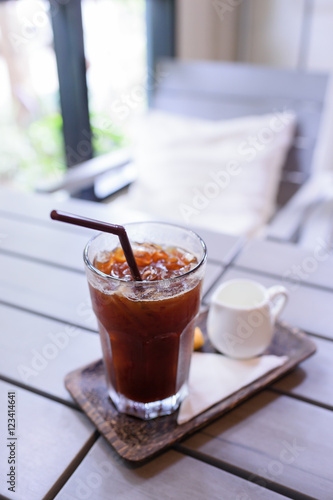 Obraz na płótnie Iced Americano black coffee on a wooden table. shallow depth of w salonie