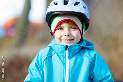 Portrait of little kid boy in bicycle helmet