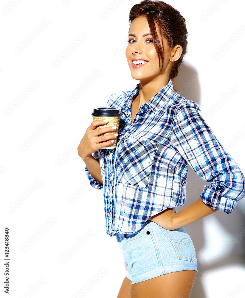 Portrait of beautiful stylish cool teenage girl in checkered shirt, holding plastic coffee cup Portrait of beautiful stylish cool teenage girl in checkered shirt, holding plastic coffee cup