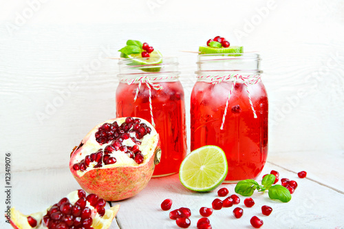 Two glasses with red pomgranate juice, lemon and mint. photo