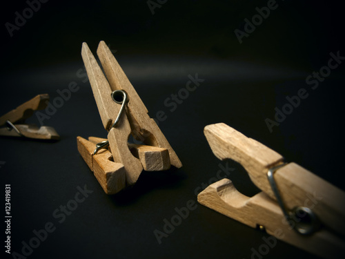 Aggressive clothespins. Fighting of wooden clothespins on dark background. Illustration aggression issues. Part of photoset. photo