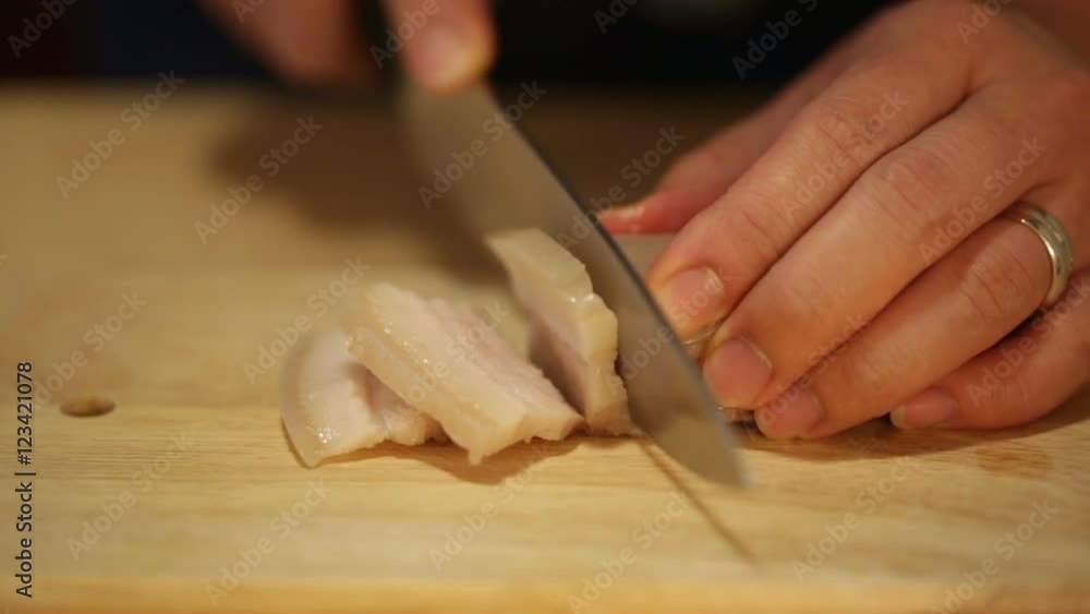Asian cook cutting boiled pork into slices to prepare traditional soup Asian cook cutting boiled pork into slices to prepare traditional soup