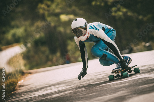 Unrecognizable man riding fast on a skateboard
