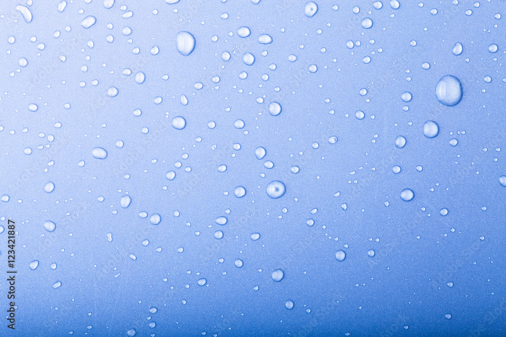 Drops of water on a color background. Blue. Toned