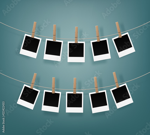 Set of Wooden Clothespins Pegs whith Blank Retro Photo Frames on Rope Close up Isolated on Background
