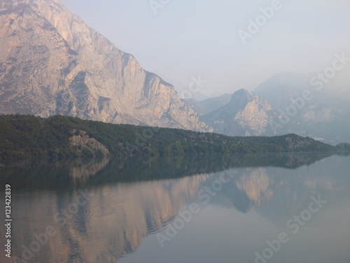 reflection of mountains in the water of lago cavedine