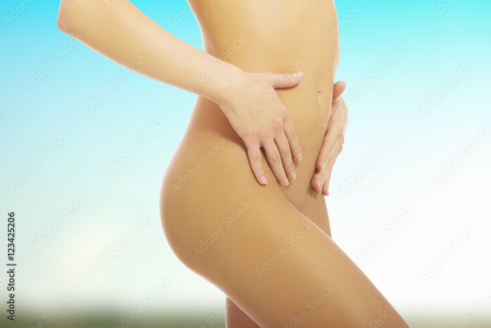 Attractive woman with her hands on her belly Attractive woman with her hands on her belly