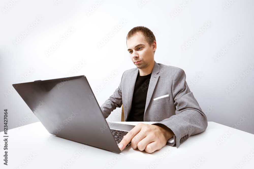 Handsome businessman working with laptop in office Handsome businessman working with laptop in office
