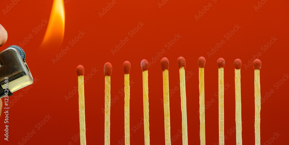 Burning matchsticks setting fire to its neighbors Burning matchsticks setting fire to its neighbors