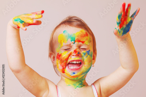 beautiful baby girl laughs painted colors, children's make-up (h