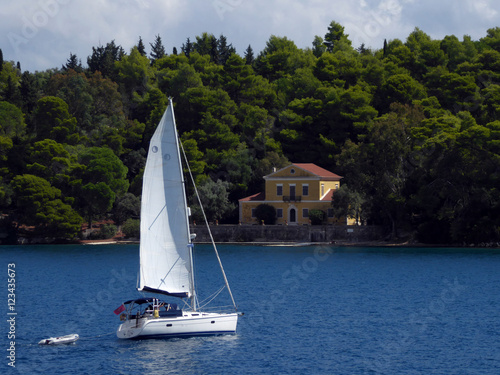 A yacht passing Madouri Island off Nidri, Lefkada (Lefkas), Greece