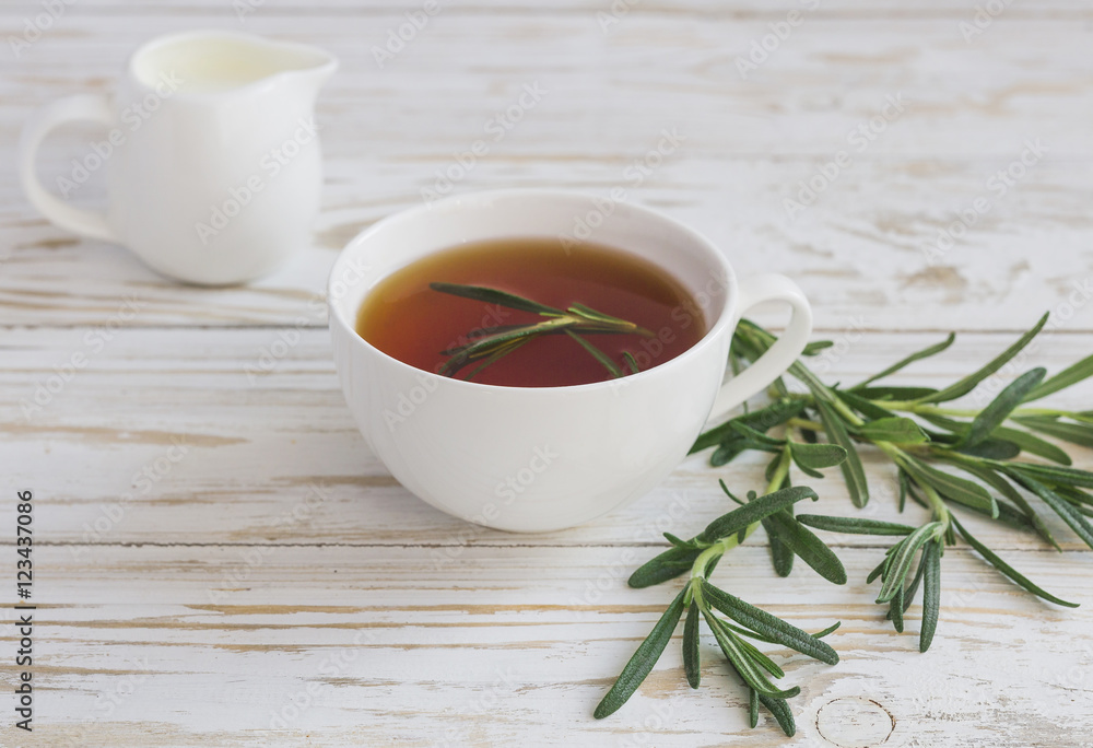 Rosemary tea and milk jar on wooden table. Rosemary tea and milk jar on wooden table.