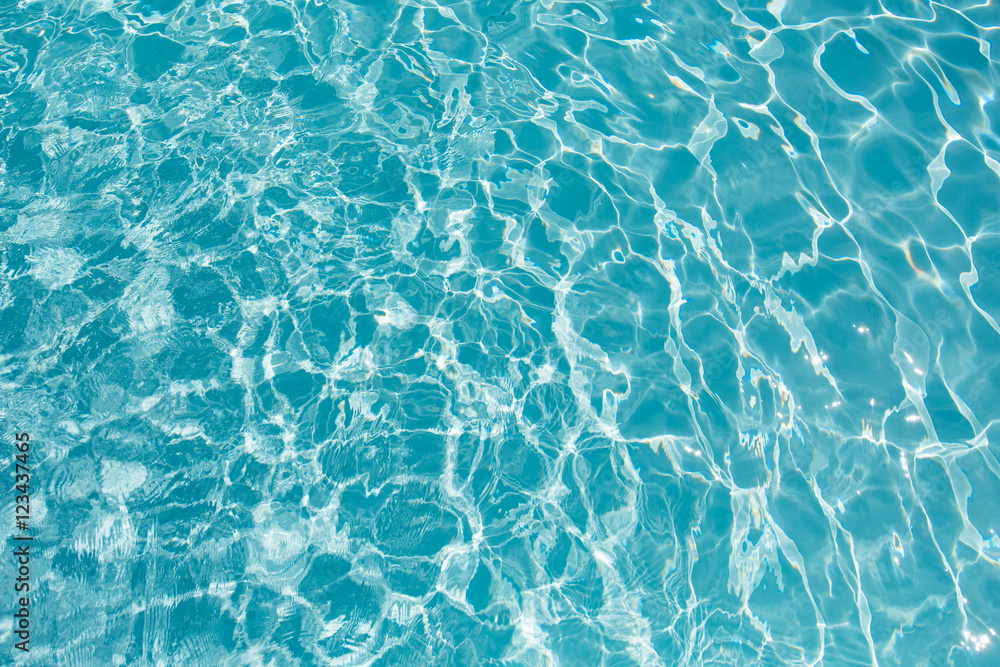 Beautiful blue water in swimming pool with sun reflection