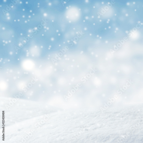 Winter background, Abstract blue lights Christmas background with falling snowflakes, copy space. For a greeting or message about promotions and sales.