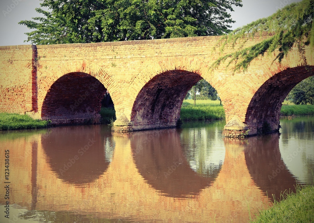 ancient arched bridge made of red bricks