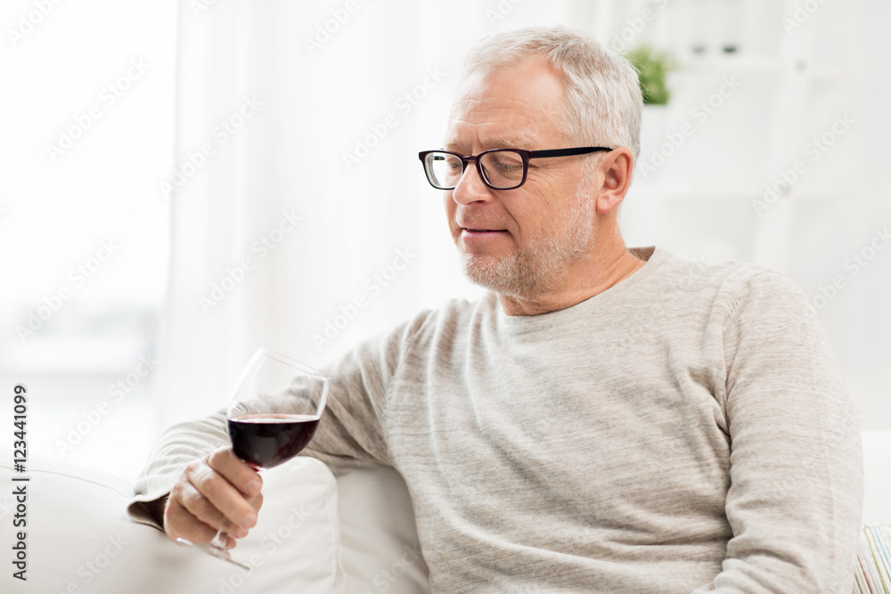 senior man drinking red wine from glass at home senior man drinking red wine from glass at home