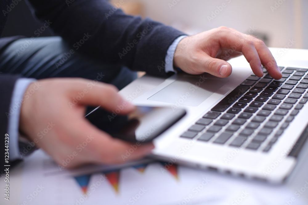 Fototapeta premium businessman working at a computer hands closeup