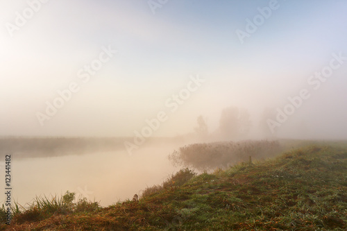 Autumn foggy morning. Dawn on the misty river