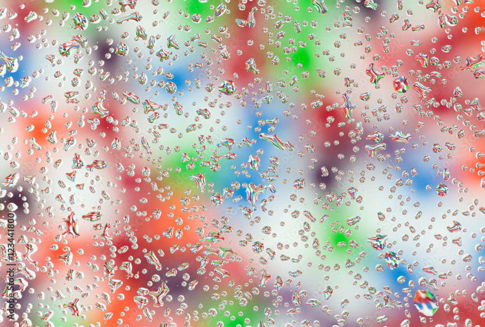 Colorful candies in the water drops.