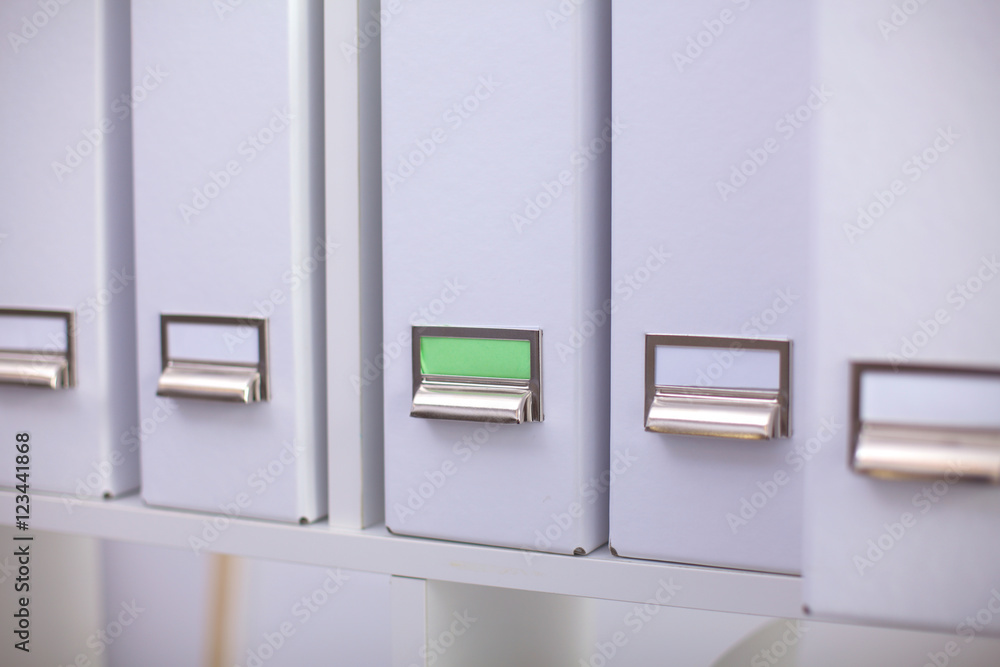 File folders, standing on shelves in the background File folders, standing on shelves in the background