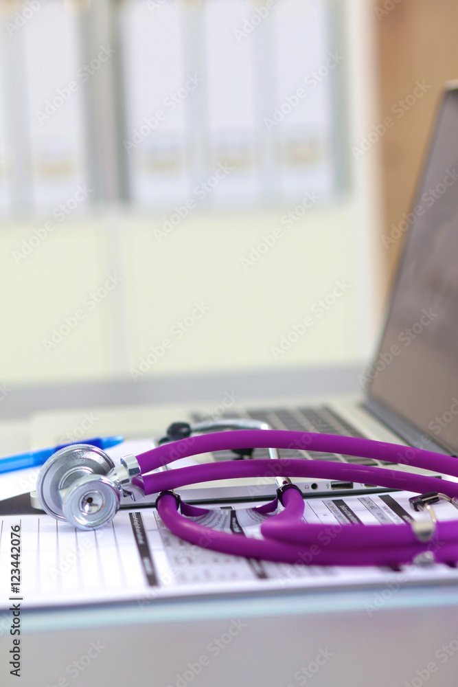 medical stethoscope near laptop on wooden table, white medical stethoscope near laptop on wooden table, white