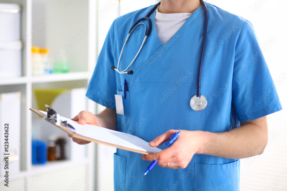 Closeup portrait of a doctor with stethoscope holding folder Closeup portrait of a doctor with stethoscope holding folder