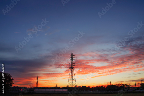 morning glow and transmission line iron tower