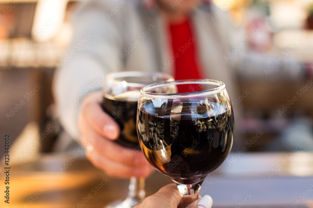 two glasses of wine in the hands of men and women with a blurred background