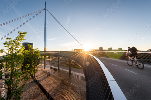 Cyclist going over the City Bridge (Byens bro) in Odense, Denmar photo