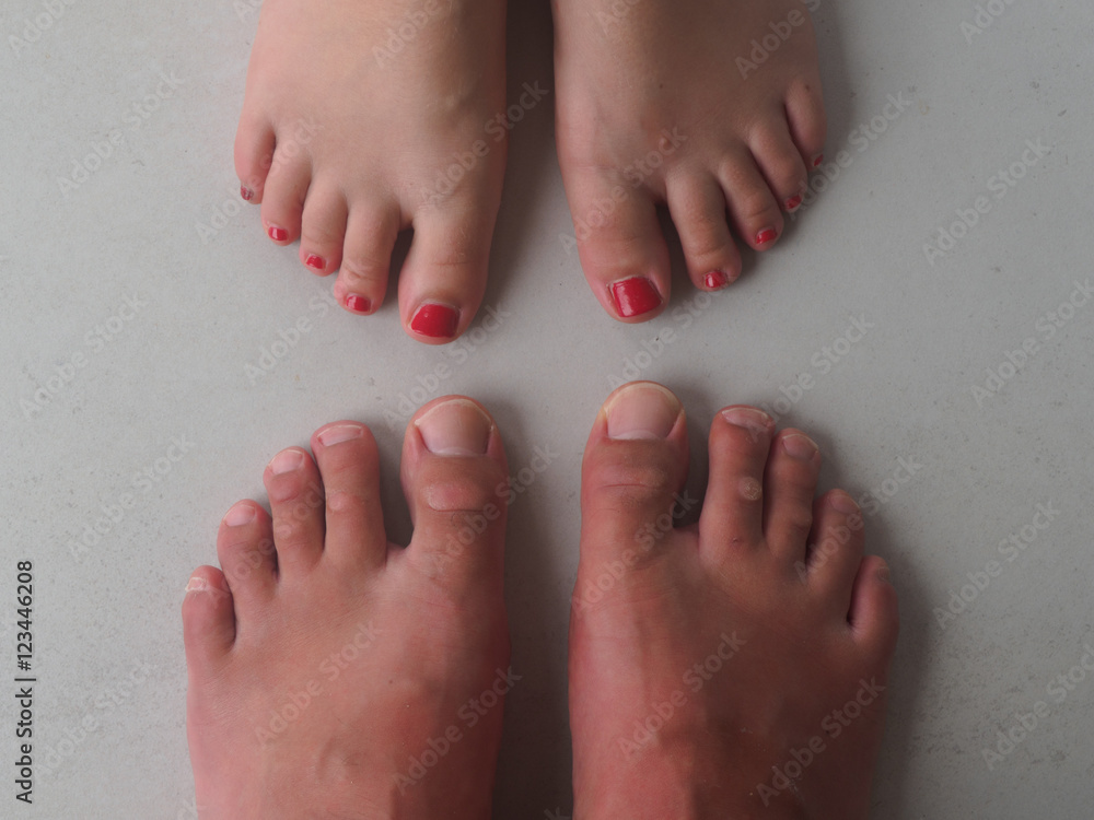 Fototapeta premium Twenty toes with partially painted nails