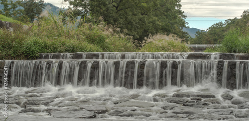 Fototapeta Naklejka Na Ścianę i Meble -  River with small waterfall