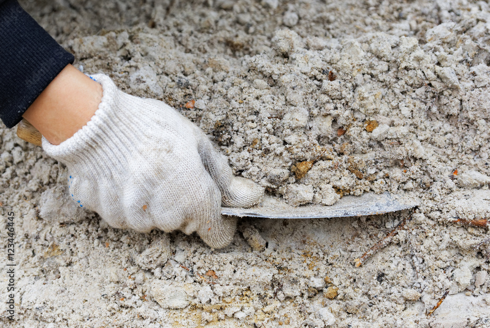 Cleaning archeology dig in sand