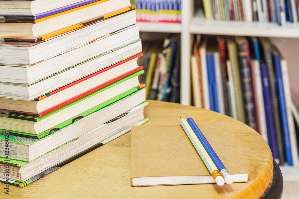 Notebook with pencil and books on chair. Notebook with pencil and books on chair.