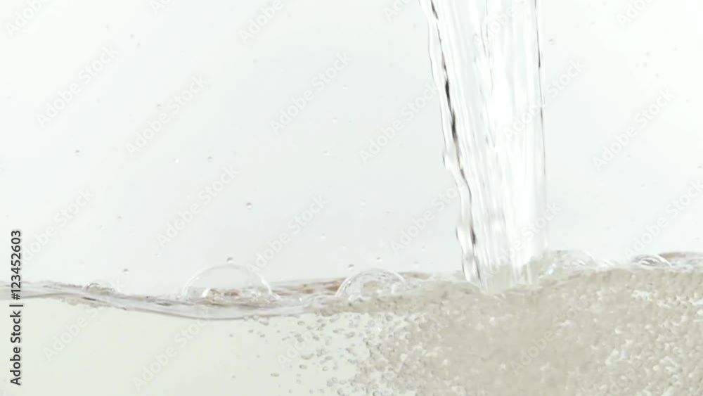 Water falling into surface on white background slow motion HD video. Water splash with bubbles. Water falling into surface on white background slow motion HD video. Water splash with bubbles.