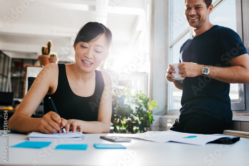 Two business people working at desk together