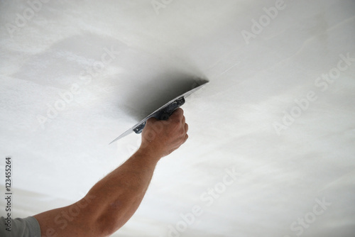 Tableau sur toile Master builder renovating the ceiling, shallow depth of field
